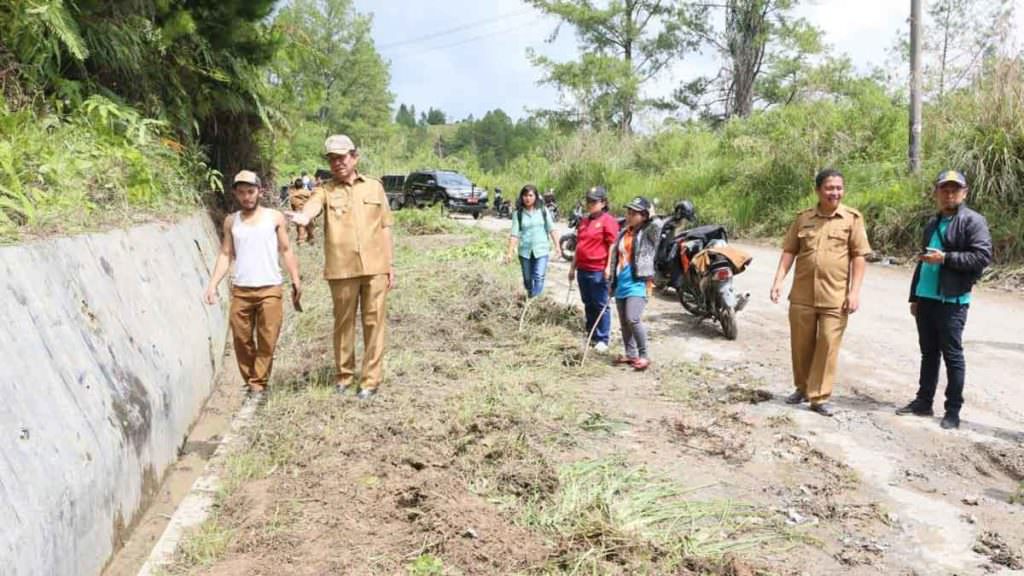 GOTONG ROYONG: Wabup Taput, Sarlandy Hutabarat gotong royong bersama ASN di sekitar Simpang 4 Hutabarat sampai Jalan Siarang-arang, Kelurahan Partali Toruan, Kecamatan Tarutung, Senin (9/12)
