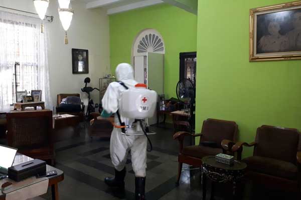 Petugas menyemprotkan disinfektan di instana Maimun, Medan