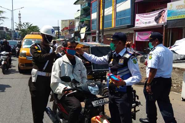 RAZIA MASKER: Plt Wali Kota Medan bersama Kadishub Kota Medan, personel Dishub Medan, dibantu Satlantas Polrestabes Medan, merazia masker kepada  pengendara di jalan raya. markus/sumut pos