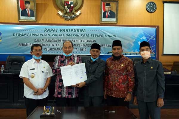 SERHAKAN: Ketua DPRD Basyaruddin Nasution menyerahkan berita acara pengesahan Perda pelaksanaan APBD TA 2019 Kota Tebingtinggi kepada Wali Kota Tebingtinggi Umar Zunaidi Hasibuan.