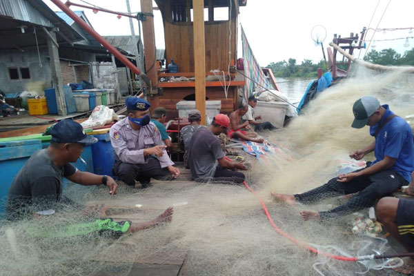 SOSIALISASI: Personel Polair Polres Sergai mensosialisasikan AKB kepada nelayan di Desa Bagan Kuala, Sergai, Selasa (14/7).