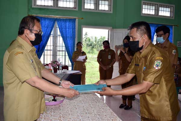 SERAHKAN: Bupati Nias Drs Sokhiatulo Laoli MM menyerahkan dokumen Dinas Sosial Kabupaten Nias kepada Hatawao Laoli SPd yang baru ditunjuk sebagai Plt Dinas Sosial Kabupaten, pada acara Sertijab yang digelar di aula pertemuan kantor Dinas Sosial Kabupaten Nias, Desa Hiliweto-Gido, Selasa (27/10) yang lalu.ade laoli/sumut pos.