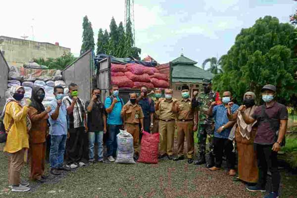 DIABADIKAN: Kadis Pertanian Kabupaten Asahan, Oktoni Eryanto diabadikan bersama perwakilan lima Koptan Asahan yang menerima bantuan 5 ton benih bawang.