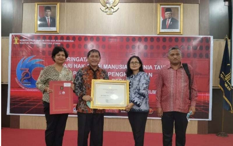 TERIMA: Bupati Karo Terkelin Brahmana saat menerima penghargaan bidang HAM di Kantor Kanwil Kemenkum HAM, Jalan Putri Hijau Medan, Senin (14/12).