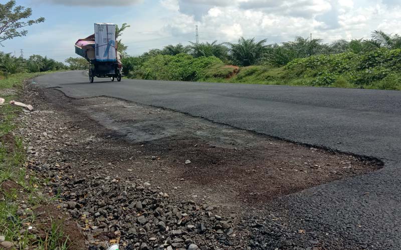 RETAK: Proyek Jalan Hotmix di Simpang Gambus yang dikerjakan PT Maringin Karya Sejati, tampak terkelupas dan retak, sedangkan permukaan jalan terasa  bergelombang, Minggu (27/20). Mukhlis Aci/Sumut Pos .