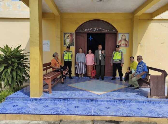 BERJAGA: Dua personel jajaran Polsek Rambutan Polres Tebingtinggi Iptu D Giawa dan Aipda Riyan Lestian melakukan pengamanan di saat jemaat gereja melakukan ibadah, Minggu (27/7).