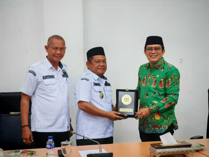 Anggota Komite I DPD RI Penrad Siagian menyerahkan cenderamata kepada Wakil Bupati Labuhanbatu H Jamri di Kantor Bupati, Rabu (23/7).