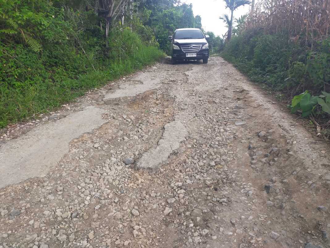 RUSAK: Mobil saat melintasi jalan rusak di Dusun Lae Bahbah, Desa Lae Luhung, Kecamatan Siempat Nempu Hilir, Kabupaten Dairi.(Rudy Sitanggang/Sumut Pos)