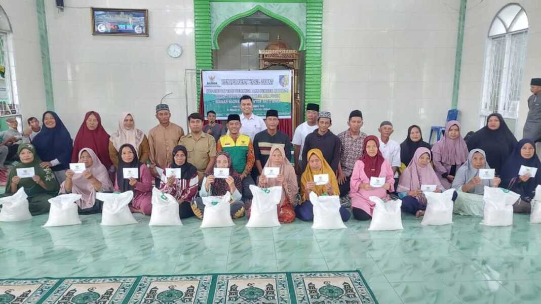 BERSAMA: Wakil Ketua II BAZNAS Batubara H Nasrullah, staf pelaksana, dua kelompok tani dan Sekdes Tanjungkubah Mhd Riadi foto bersama warga mustahik di Masjid Desa Tanjungkubah. (File foto Baznas Batubara)
