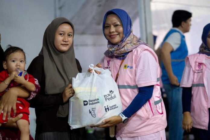 SALURKAN: Wakil Ketua Srikandi PLN UIP Sumbagut Effiaty Polapa, menyalurkan bantuan asupan gizi.