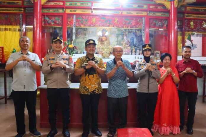 BERSAMA: Wali Kota Tebingtinggi Iman Irdian Saragih dan Kapolres Tebingtinggi AKBP Rina Frillya foto bersama pengurus Kelenteng Jiu Li Dong, Snein (17/2). Azan purba