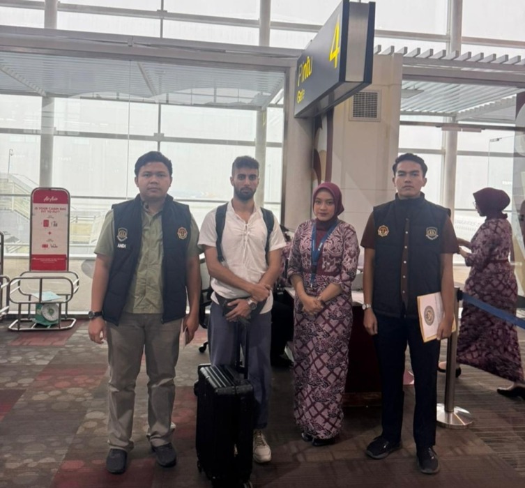 DEPORTASI: Petugas Kantor Imigrasi Kelas II TPI Belawan saat mendeportasi warga negara Belgia yang terbukti melanggar aturan keimigrasian.