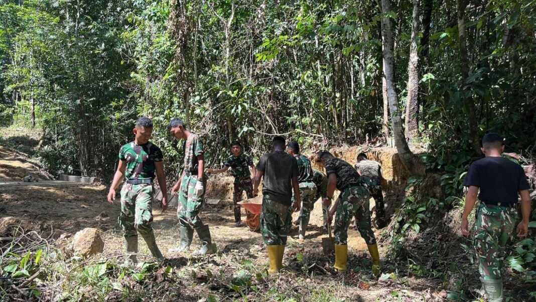 BANGUN JEMBATAN: Prajurit TNI saat sedang melakukan pembangunan Jembatan Aramco, di Gunungsitoli. (Istimewa/Sumut Pos)