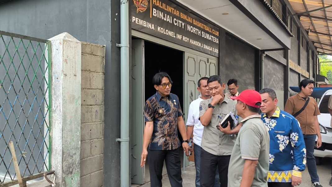 DAMPINGI: Kadis PUTR Binjai Wahyu Umara (pegang buku catatan) saat mendampingi Wakil Wali Kota Binjai Hasanul Jihadi, melihat Jalan Wahidin Baru seputaran Pasar Tavip yang akan diperbaiki tahun ini. (Teddy Akbari/Sumut Pos)